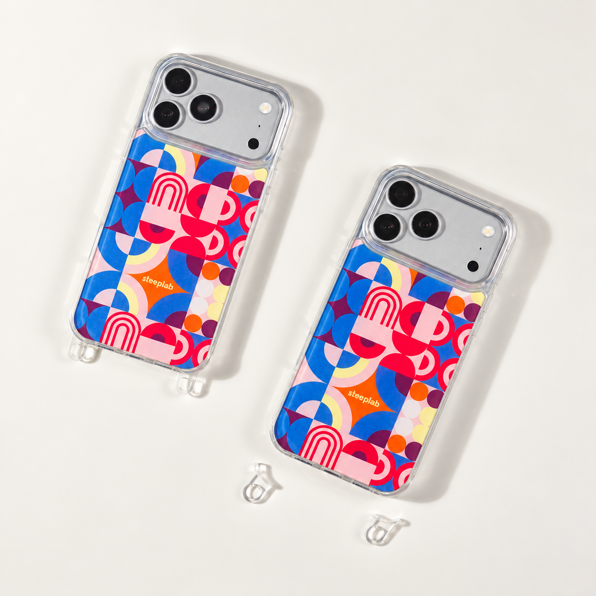 Color Play Freehand Case shown with clear removable hooks attached and removed on a soft ivory studio background.