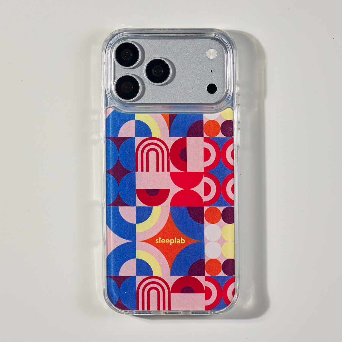 Freehand Case in Color Play for iPhone 18 Pro Max, multicolor geometric pattern, shown from the back on a neutral studio background.