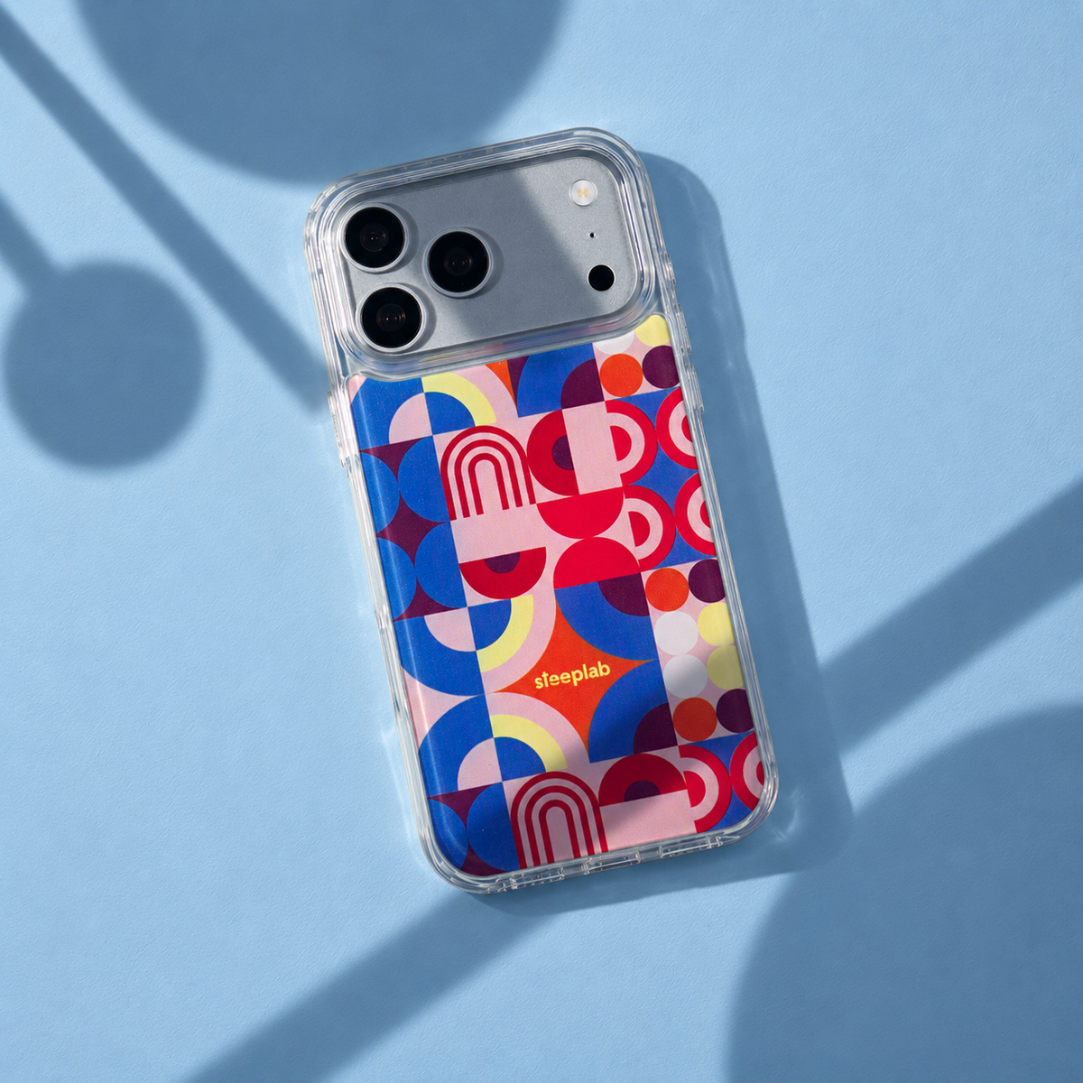 Freehand Case in Color Play for iPhone 18 Pro Max, multicolor geometric pattern, with patterned studio light and shadows.