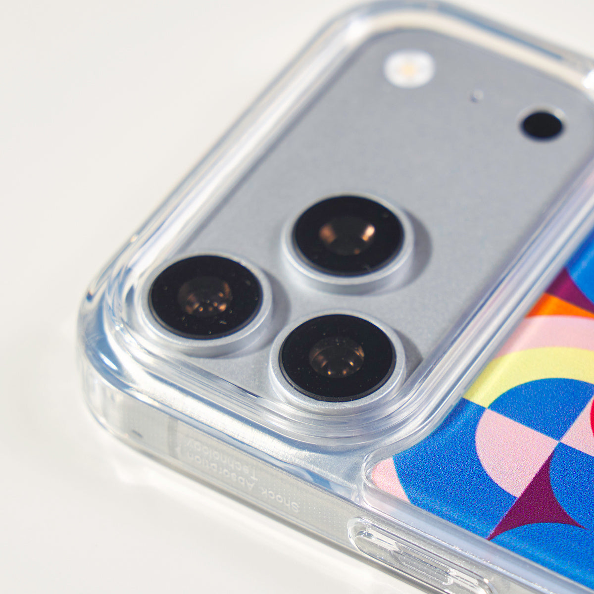 Centered close-up of the three camera lenses and raised Freehand Case edges