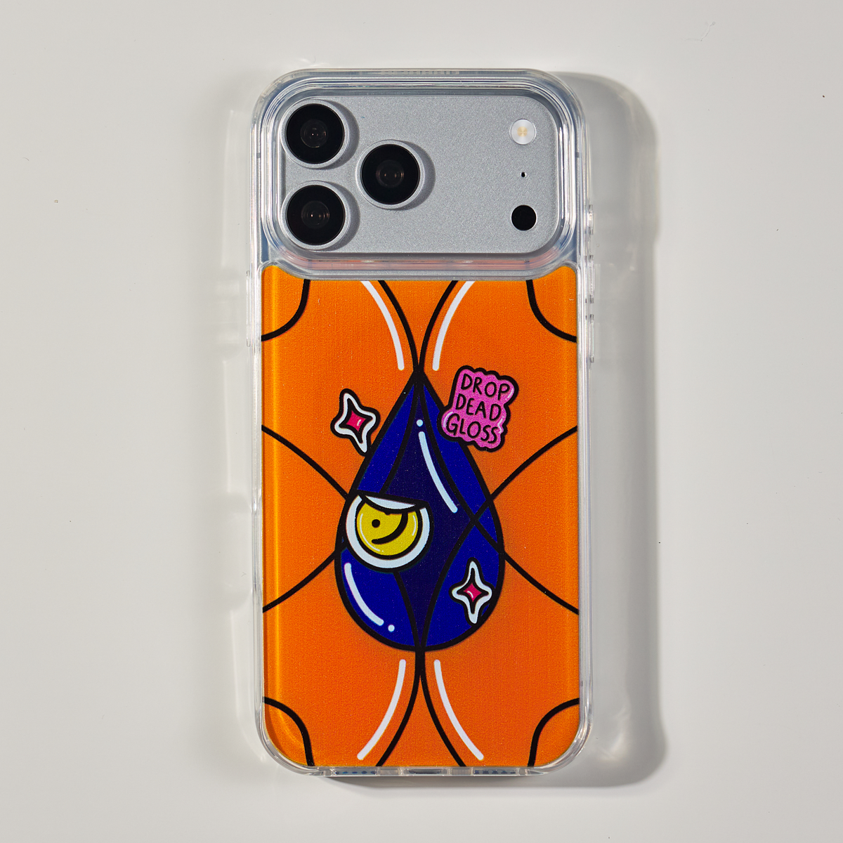 Freehand Case in Gloss Drop for iPhone 18 Pro Max, orange design with a blue illustrated drop, shown from the back on a neutral studio background.