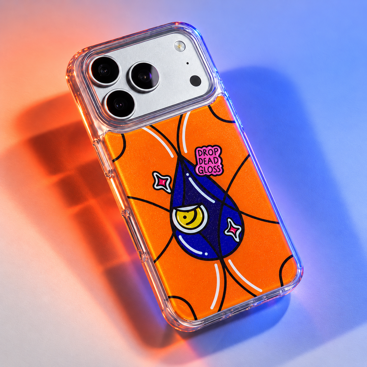 Freehand Case in Gloss Drop for iPhone 18 Pro Max, orange design with a blue illustrated drop, under colored gel studio lighting.