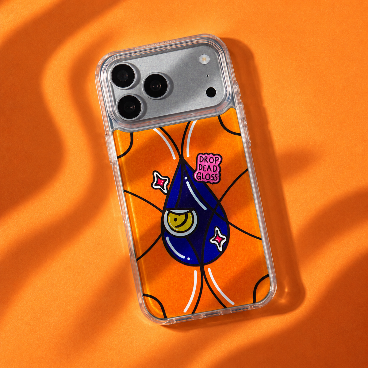 Freehand Case in Gloss Drop for iPhone 18 Pro Max, orange design with a blue illustrated drop, with patterned studio light and shadows.