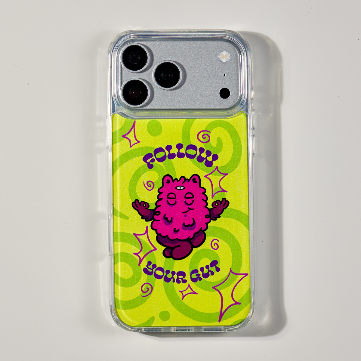 Freehand Case in Gut Feeling for iPhone 18 Pro Max, lime design with a pink illustrated character, shown from the back on a neutral studio background.