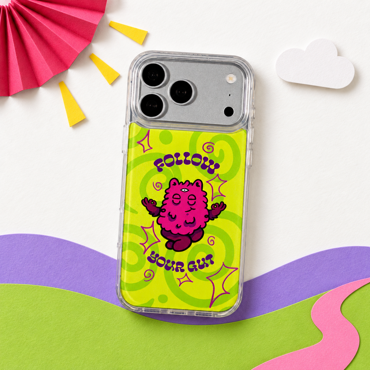 Freehand Case in Gut Feeling for iPhone 18 Pro Max, lime design with a pink illustrated character, in a playful colored-paper scene.