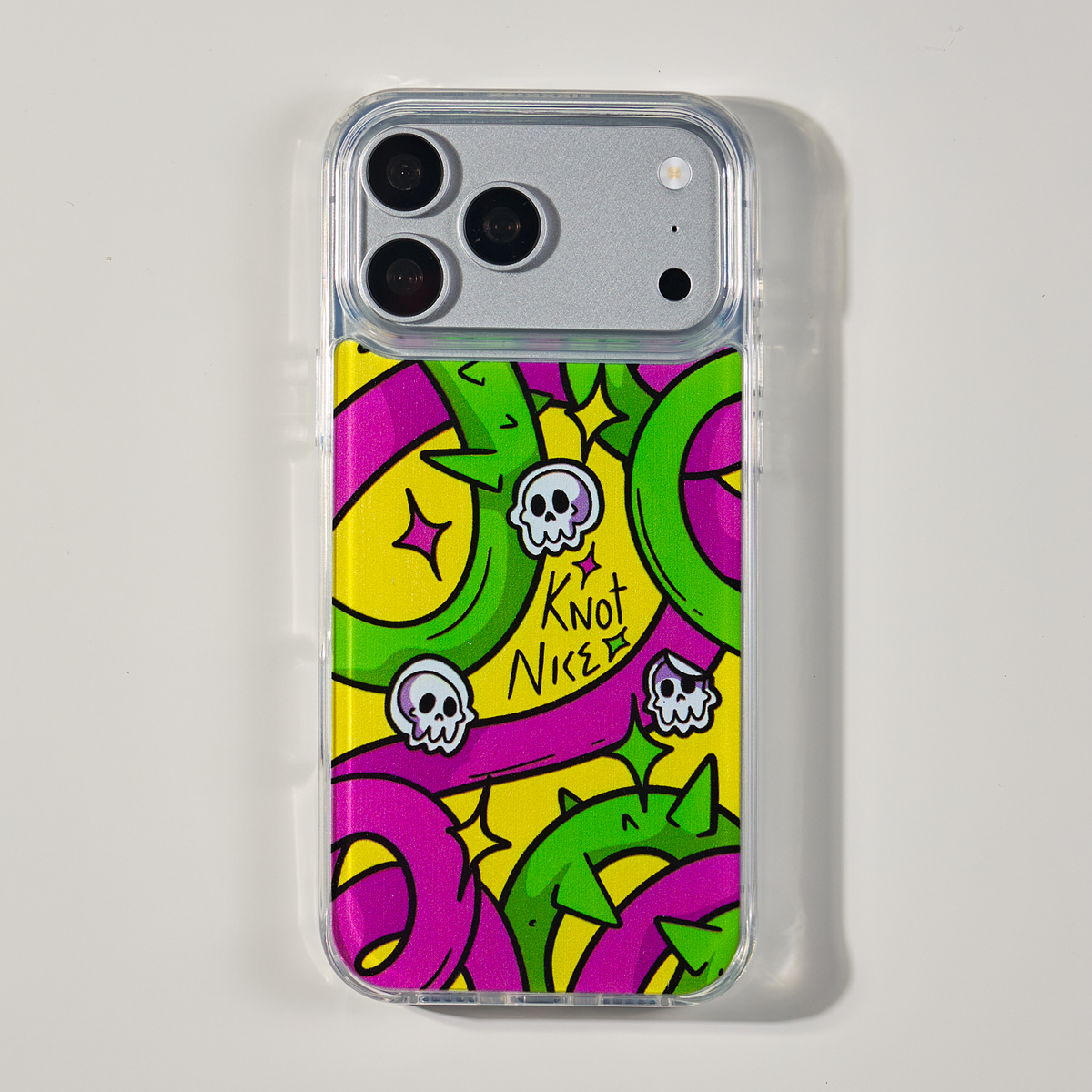 Freehand Case in Neon Knots for iPhone 18 Pro Max, bright yellow, pink and green ribbon design, shown from the back on a neutral studio background.