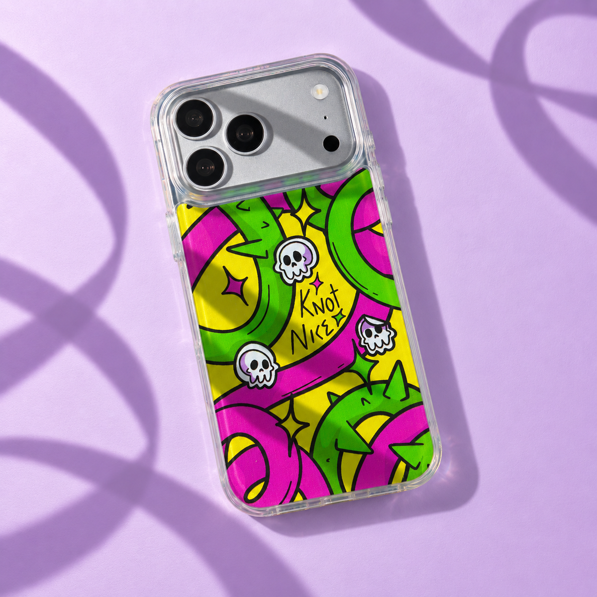 Freehand Case in Neon Knots for iPhone 18 Pro Max, bright yellow, pink and green ribbon design, with patterned studio light and shadows.