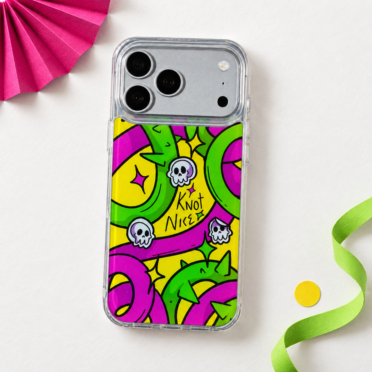 Freehand Case in Neon Knots for iPhone 18 Pro Max, bright yellow, pink and green ribbon design, in a playful colored-paper scene.