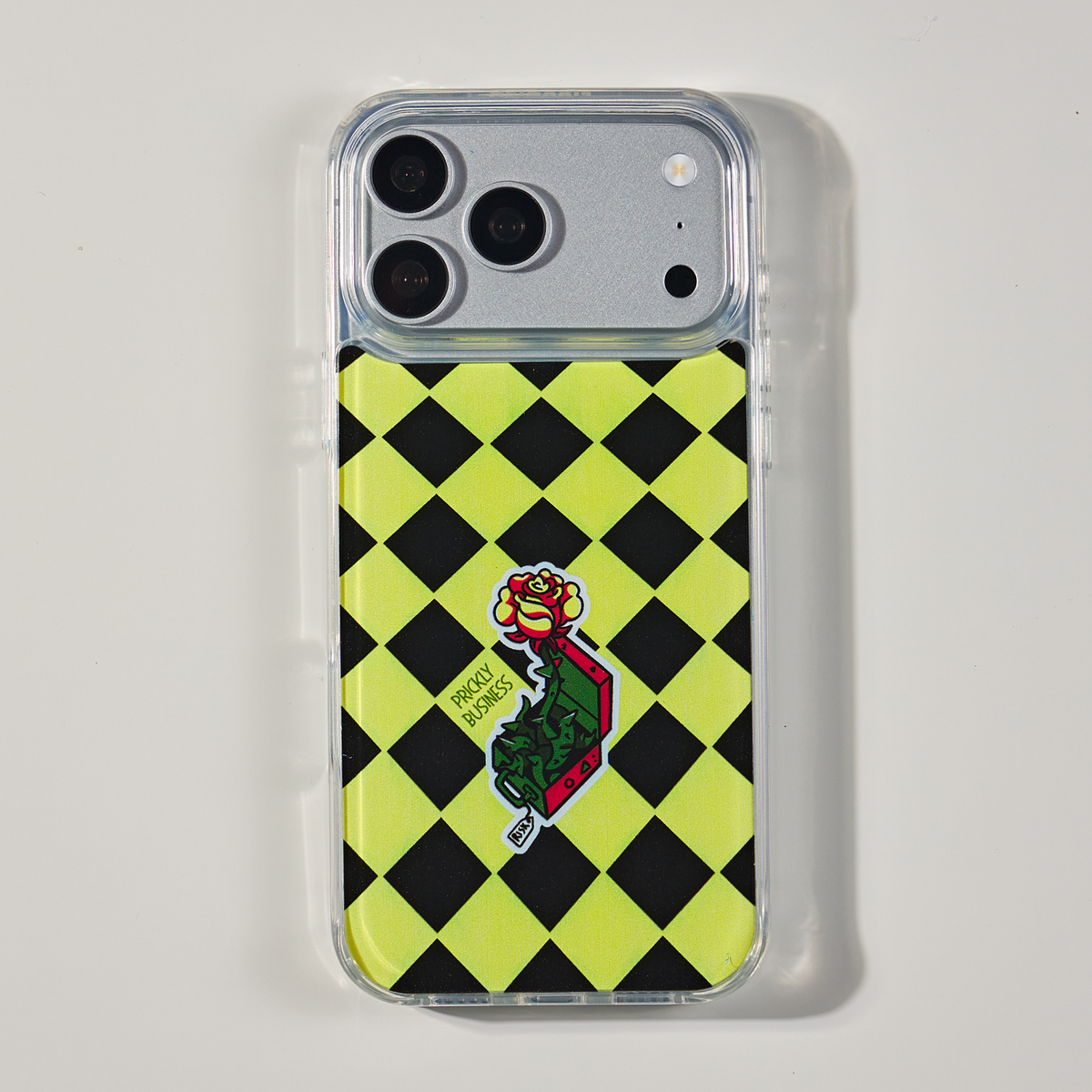 Freehand Case in Prickly Business for iPhone 18 Pro Max, chartreuse and black checkerboard design, shown from the back on a neutral studio background.