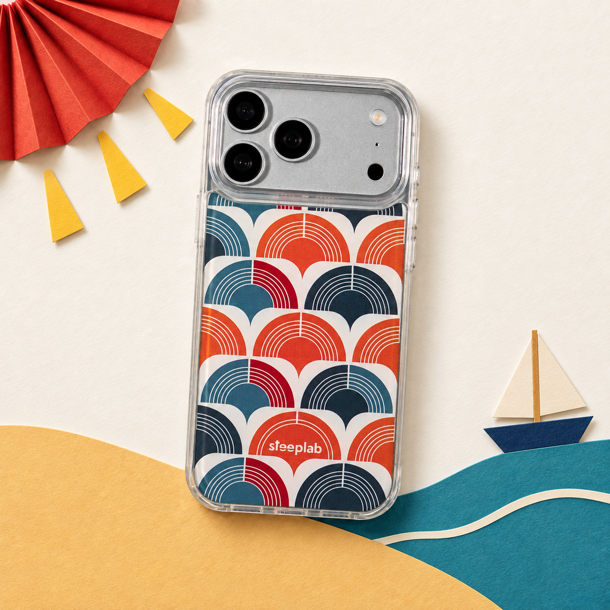 Freehand Case in Retro Ripple for iPhone 18 Pro Max, red and blue repeating arch pattern, in a playful colored-paper scene.
