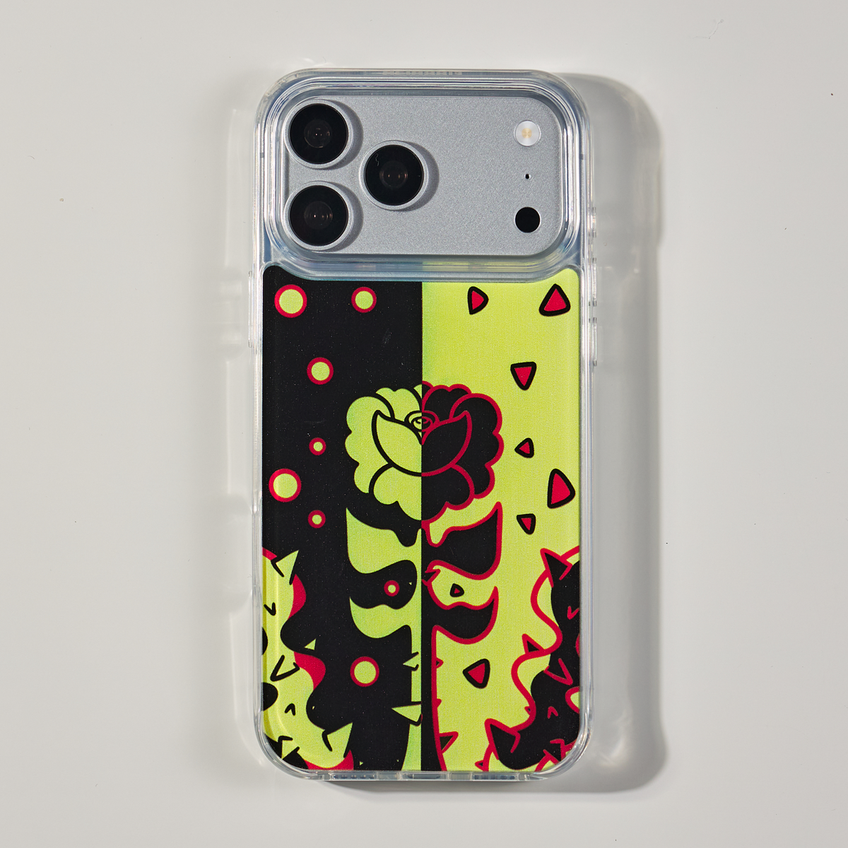 Freehand Case in Split Bloom for iPhone 18 Pro Max, black and chartreuse split floral design, shown from the back on a neutral studio background.