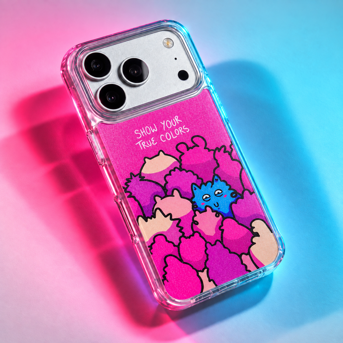 Freehand Case in True Colors for iPhone 18 Pro Max, pink design with colorful illustrated characters, under colored gel studio lighting.