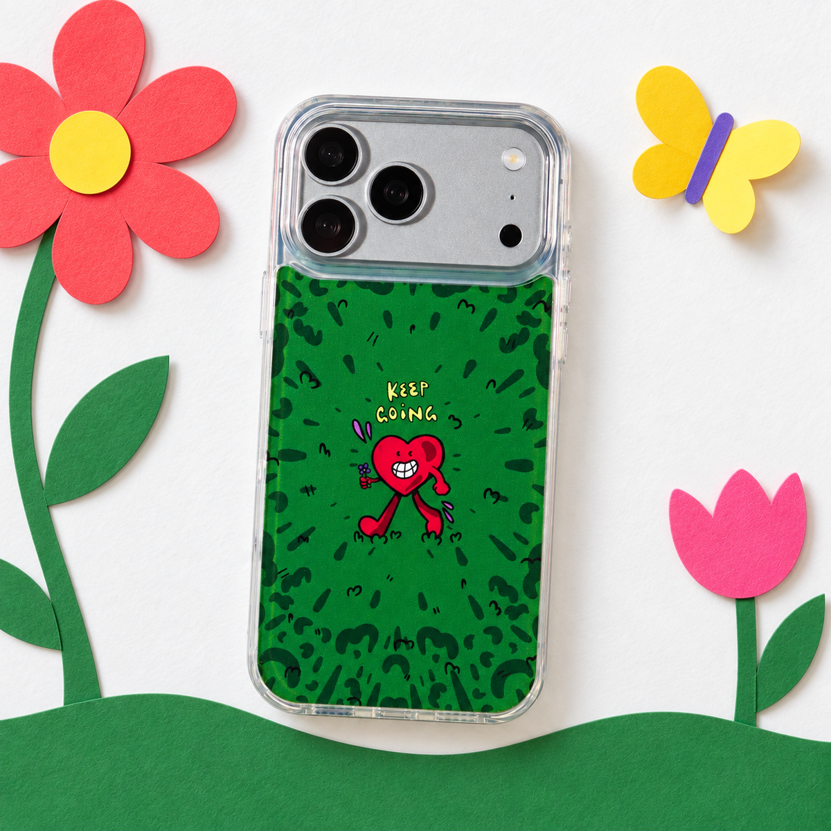 Freehand Case in Wild Heart for iPhone 18 Pro Max, green doodle design with a red walking heart, in a playful colored-paper scene.